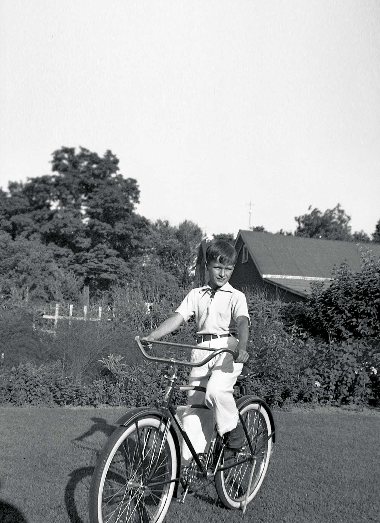 John Ashbery riding a bicycle as a young man